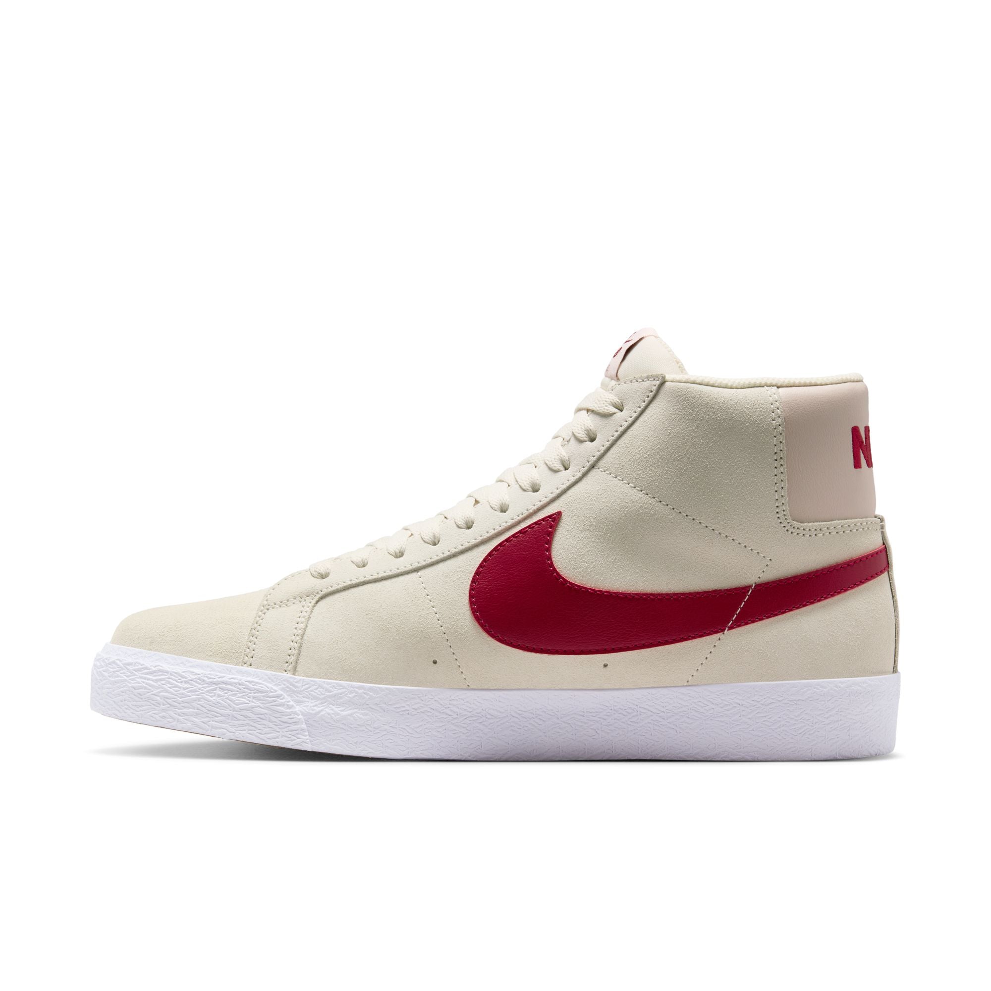 Beige nike sb blazer mid skateboard sneaker with red swoosh logo on a white background