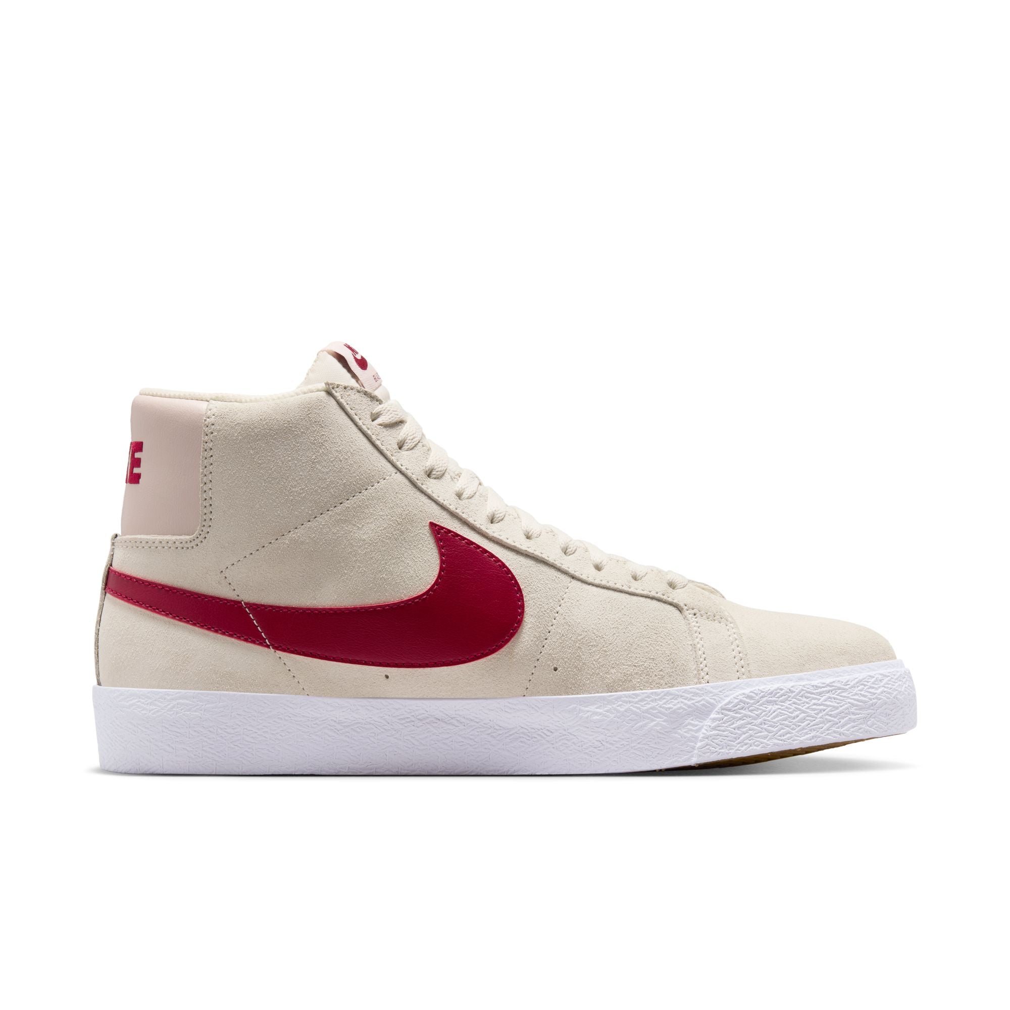Beige nike sb blazer mid skateboard sneaker with red swoosh logo on a white background