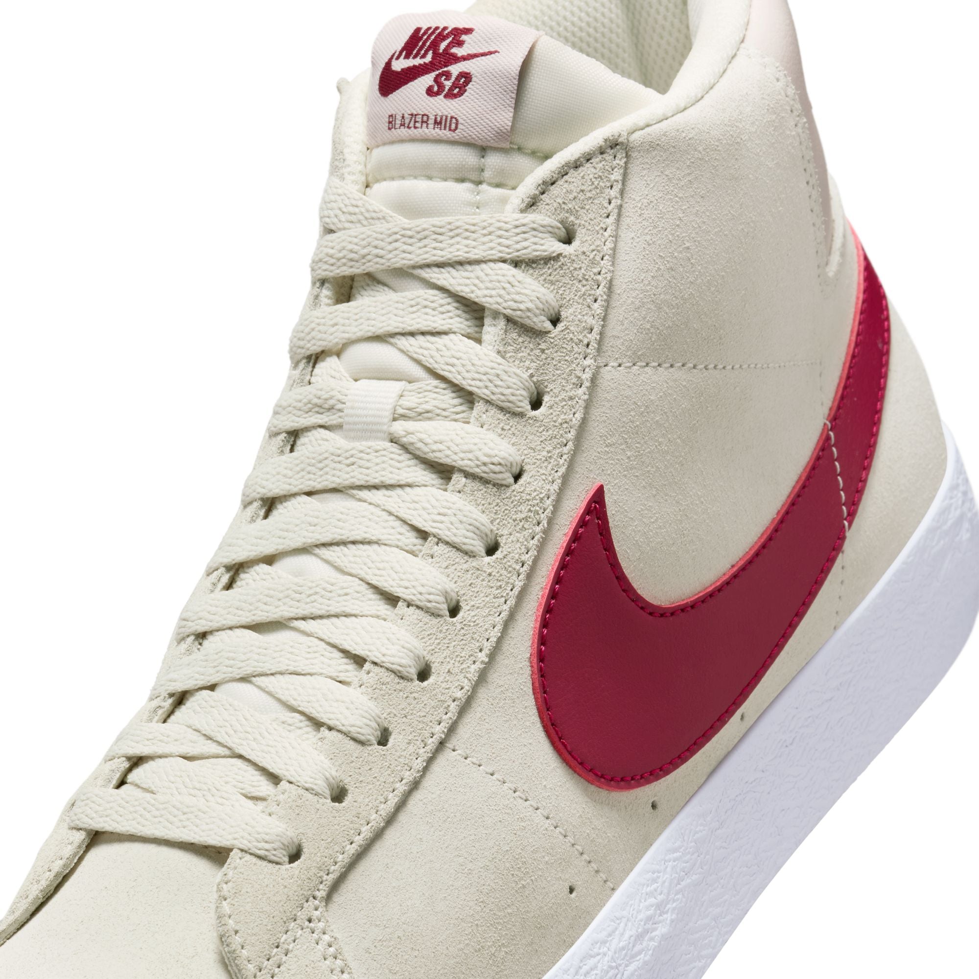 Beige nike sb blazer mid skateboard sneaker with red swoosh logo on a white background