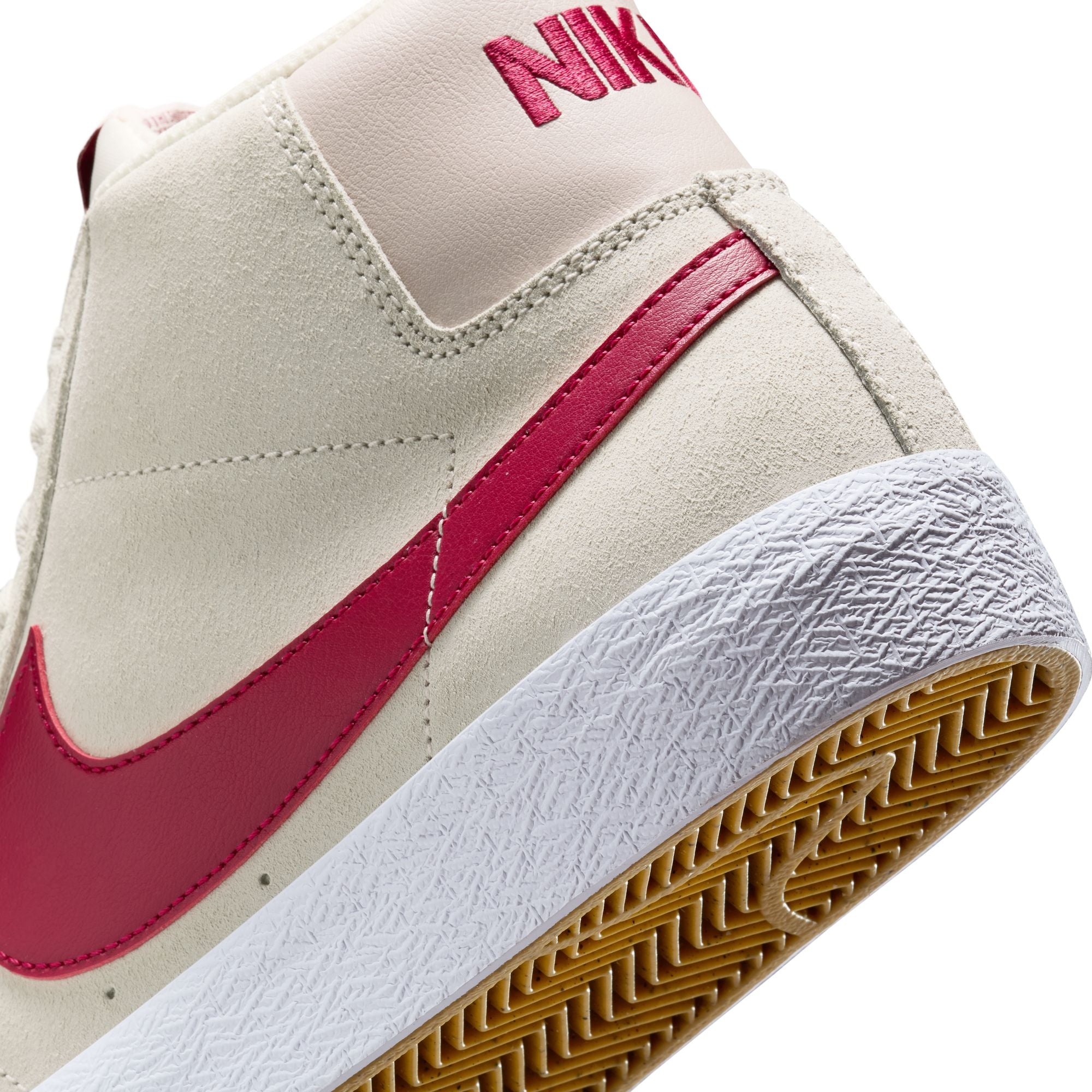 Beige nike sb blazer mid skateboard sneaker with red swoosh logo on a white background