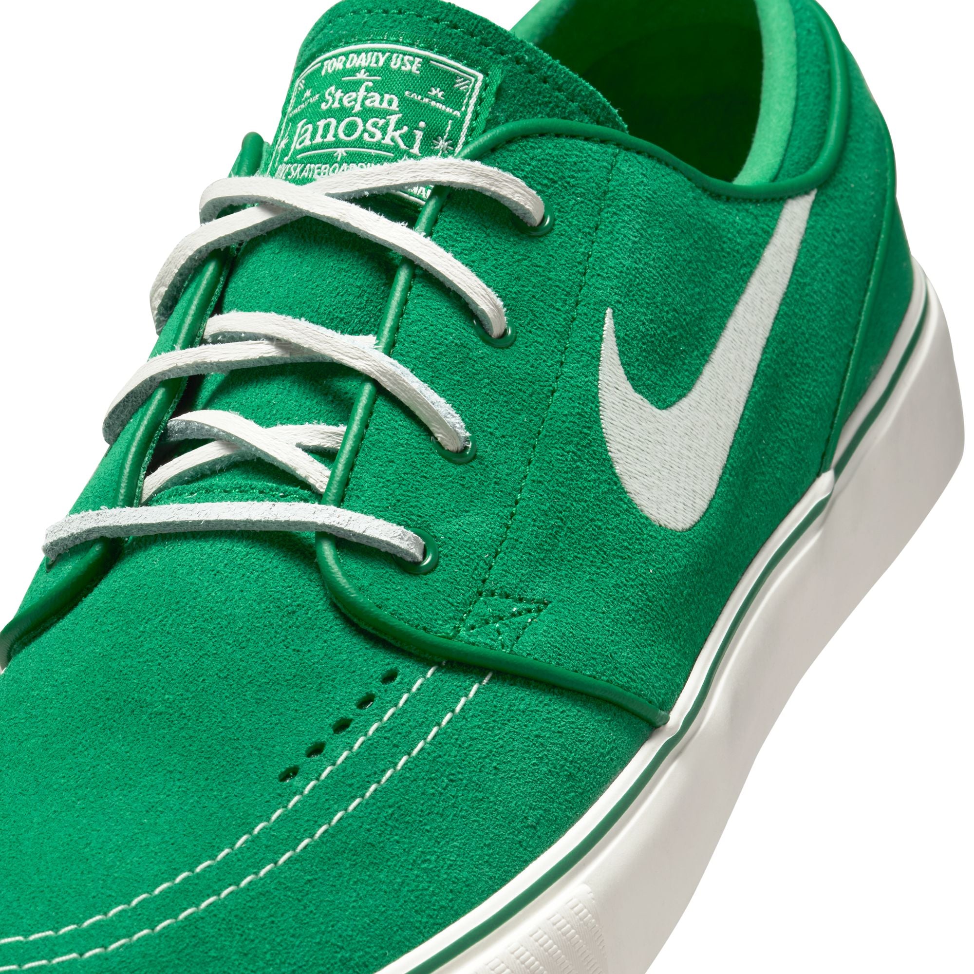 Green nike sb janoski skateboard sneaker with white swoosh logo on a white background