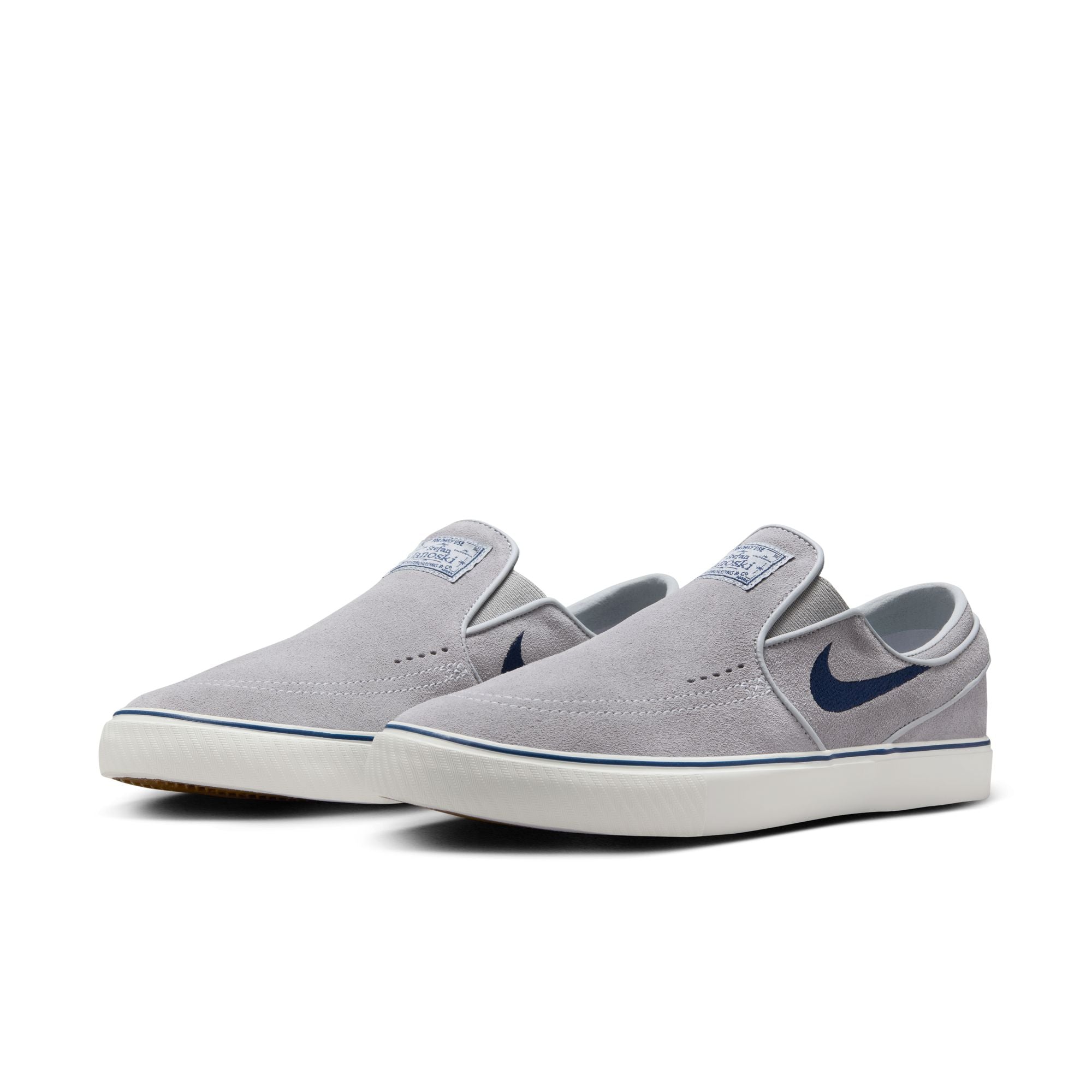 grey men's nike sb janoski slip-on with navy swoosh and white sole