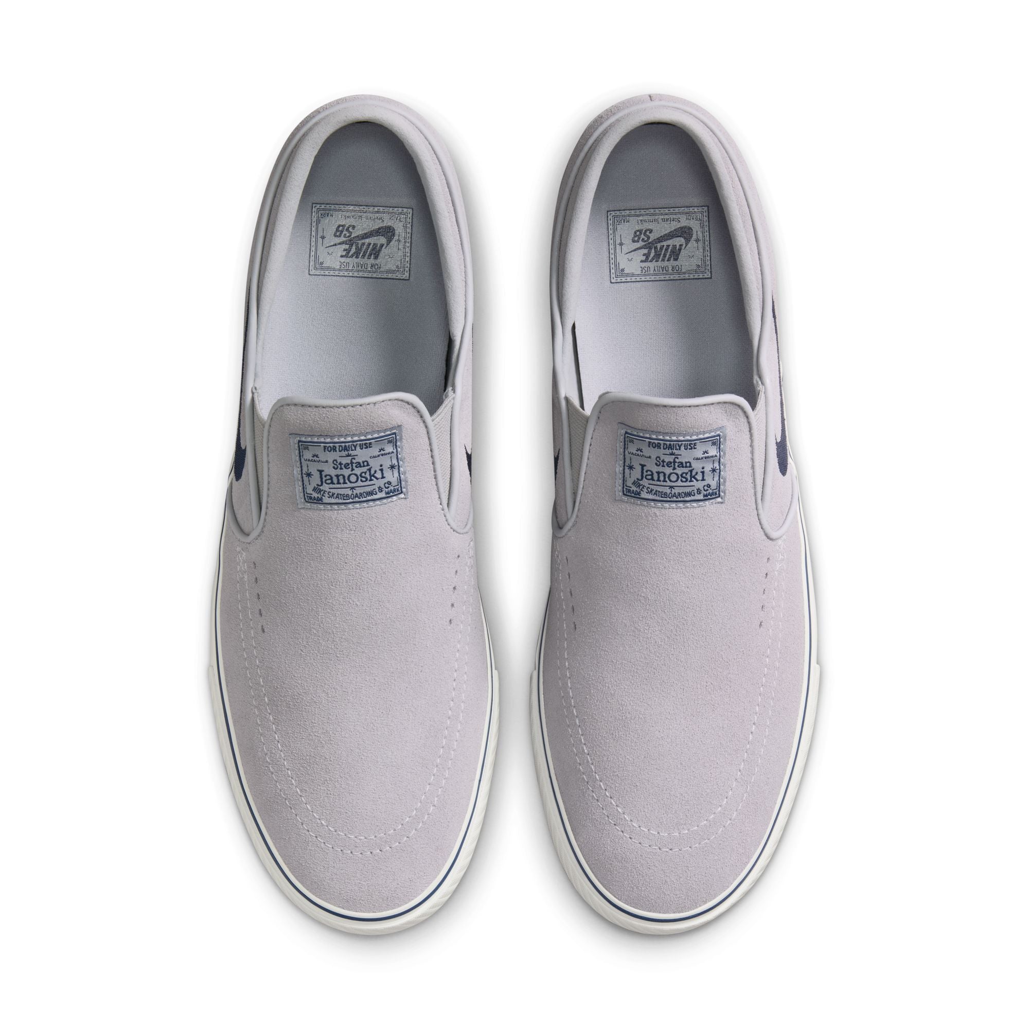 grey men's nike sb janoski slip-on with navy swoosh and white sole