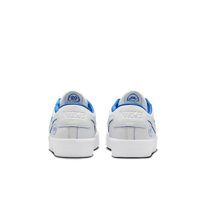 all white nike sb 20th anniversary grant taylor anniversary low top skate shoe with blue undertones and white sole