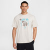 off white nike sb max90 skate tee shirt featuring an elephant and butterfly in brown with 2 tourches, a horseshoe and nike sb in light blue