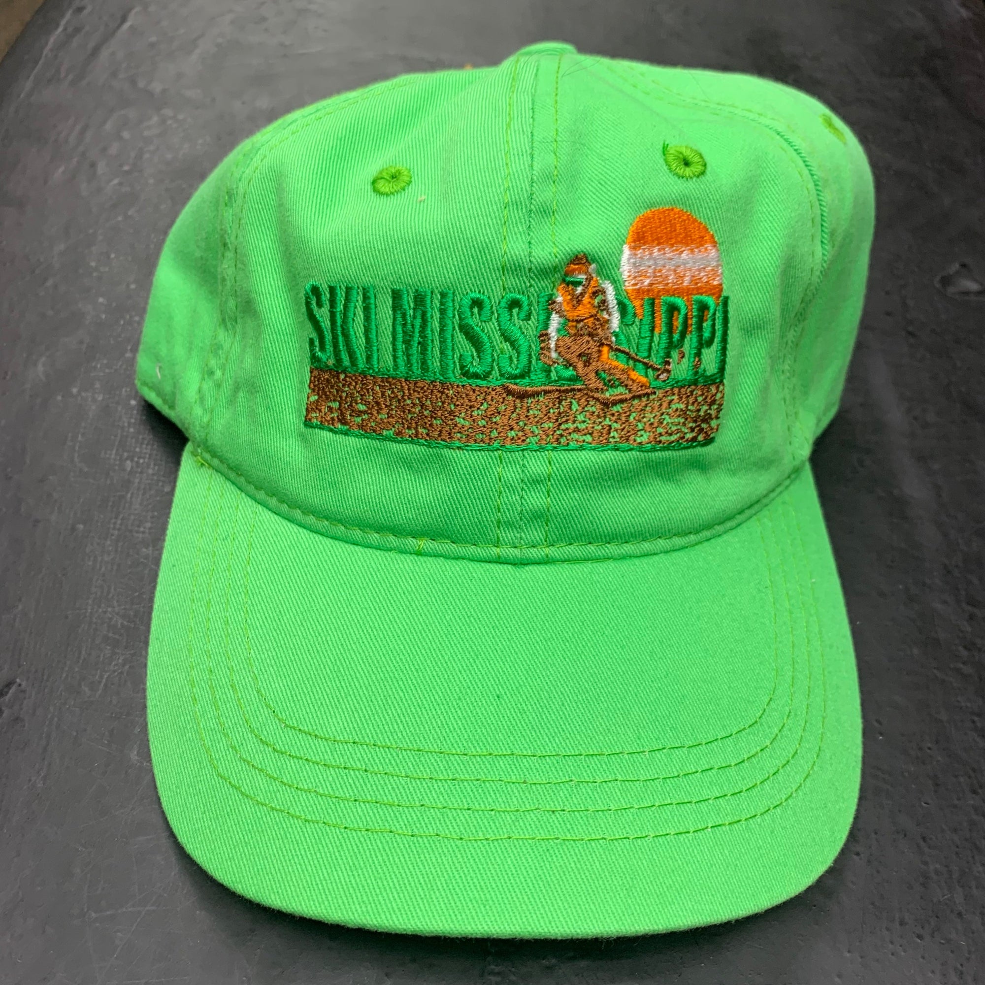 green embroidered hat featuring the ski mississippi logo in green brown and orange