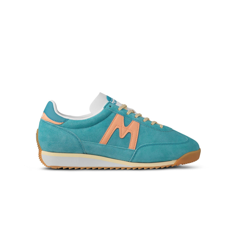 blue karhu mestari women's shoe with peach orange M logo and yellow and white sole