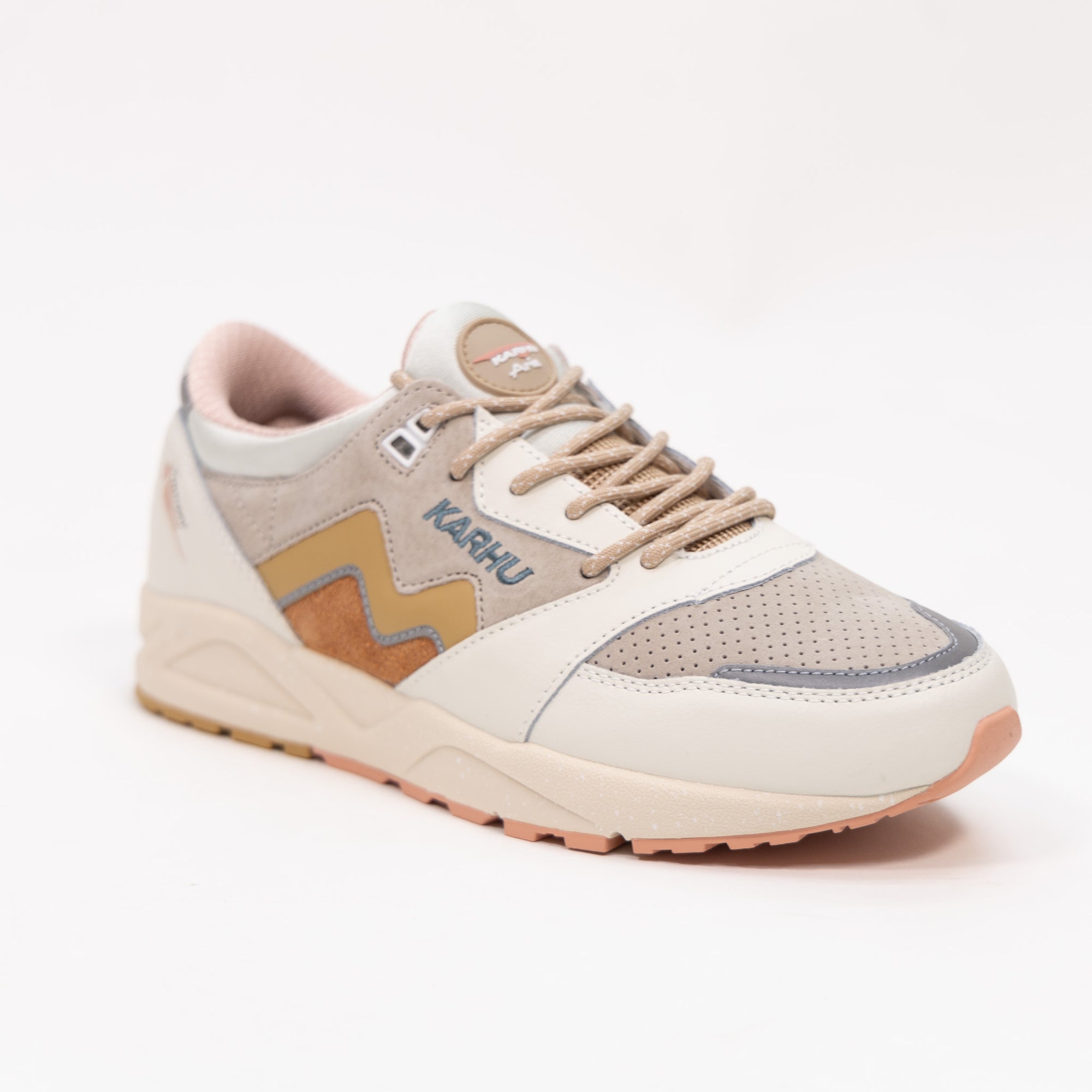 off white karhu women's comfort shoe with gold and orange detail