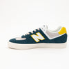 green and white men's new balance shoe with white sole and yellow detail available in standard and wide