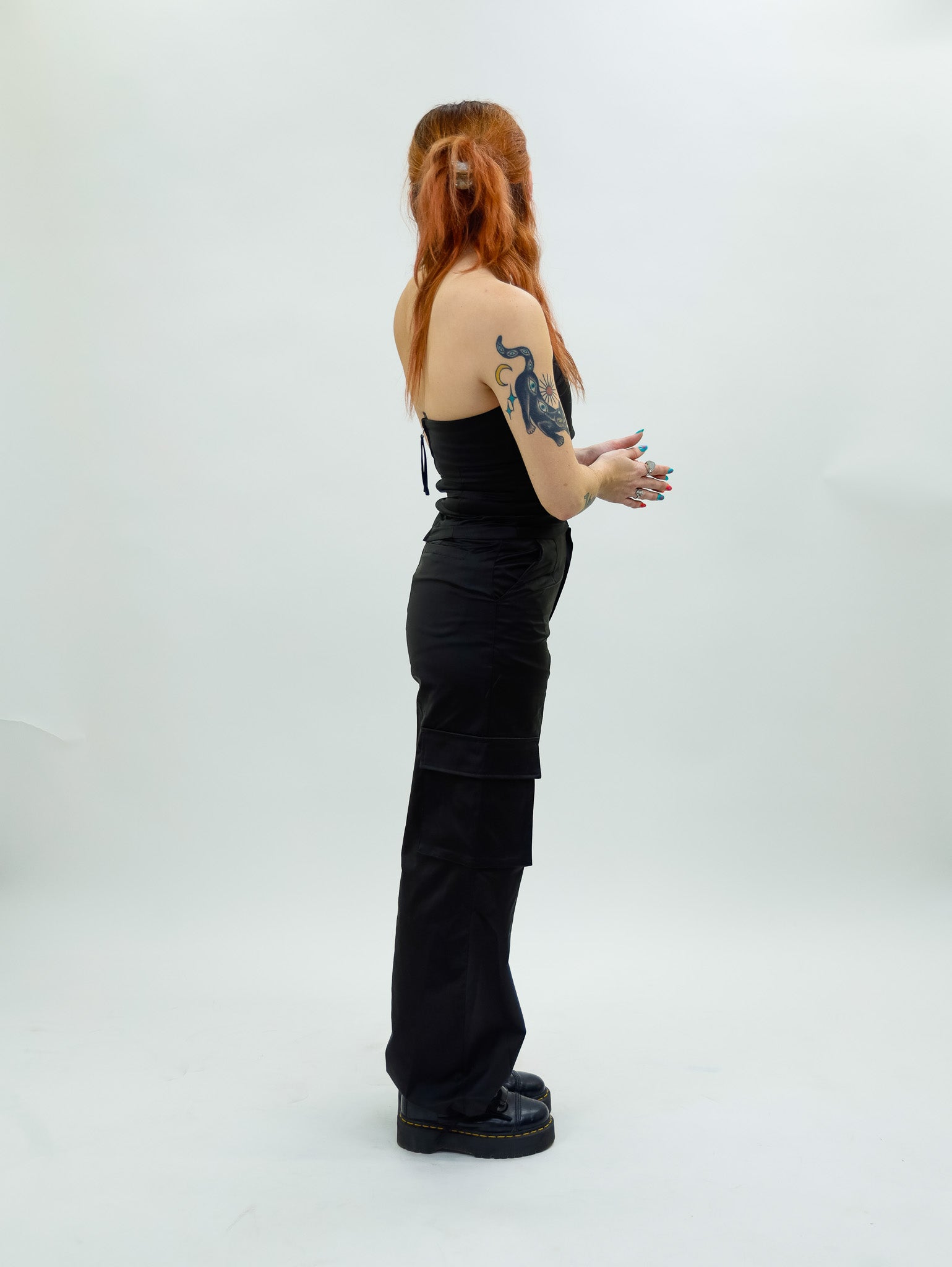 black nia Mid-rise thick satin parachute pants featuring patch pockets and adjustable ties at the ankles