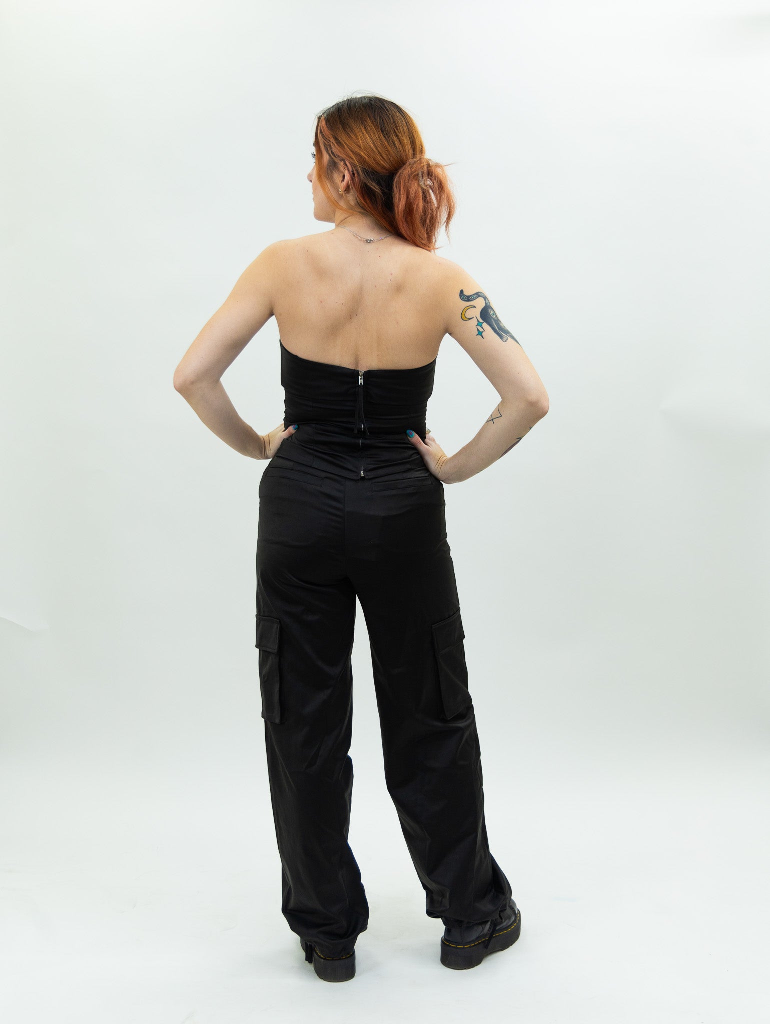 black nia Mid-rise thick satin parachute pants featuring patch pockets and adjustable ties at the ankles