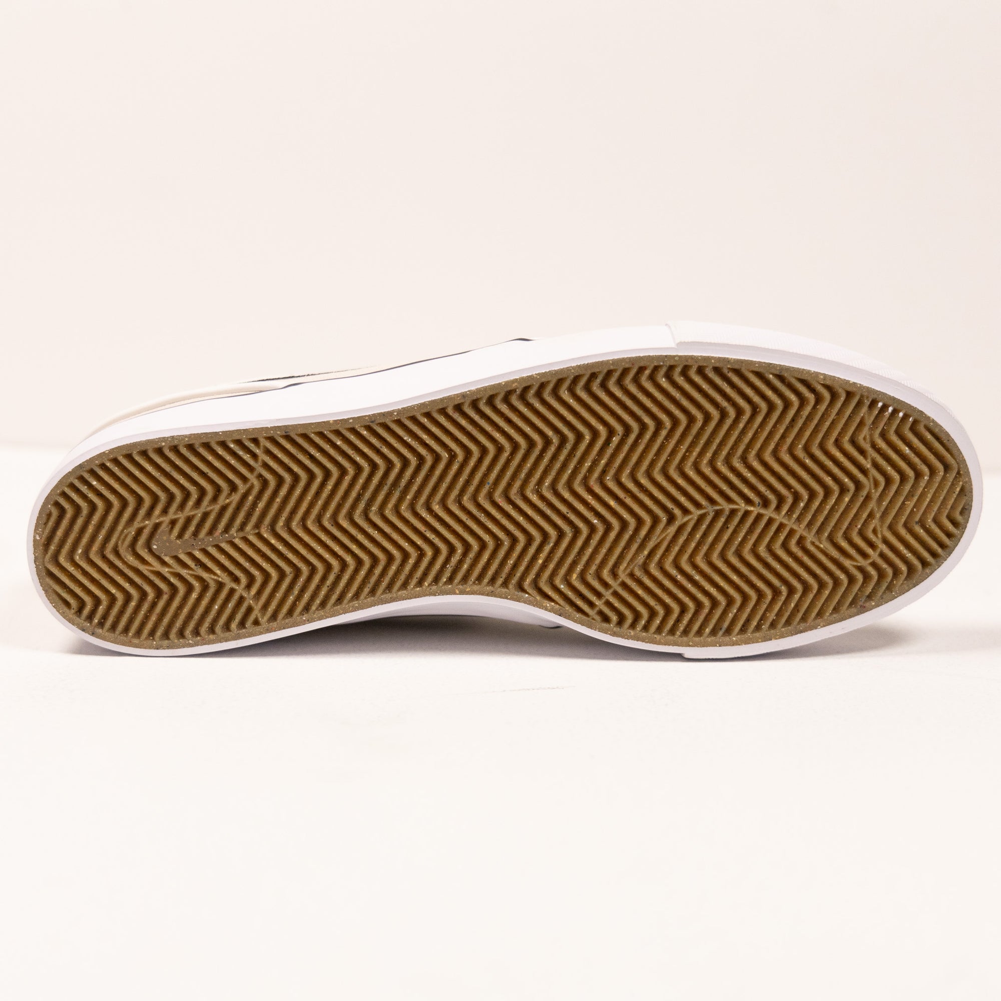 white nike sb stefan janoski men's skate shoe with black swoosh and white sole