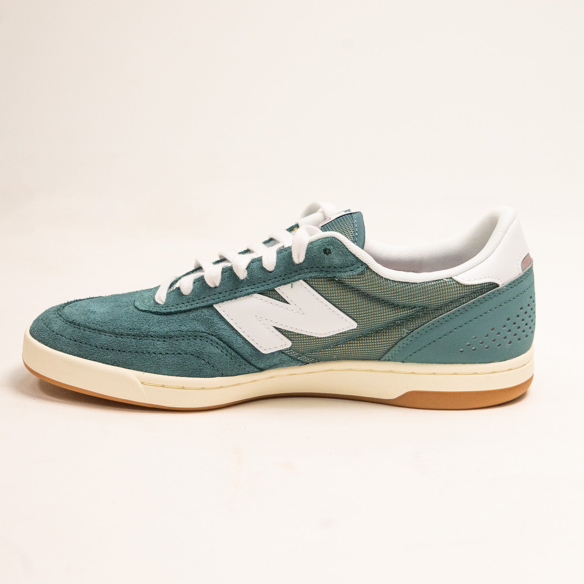 green men's new balance shoe with white sole