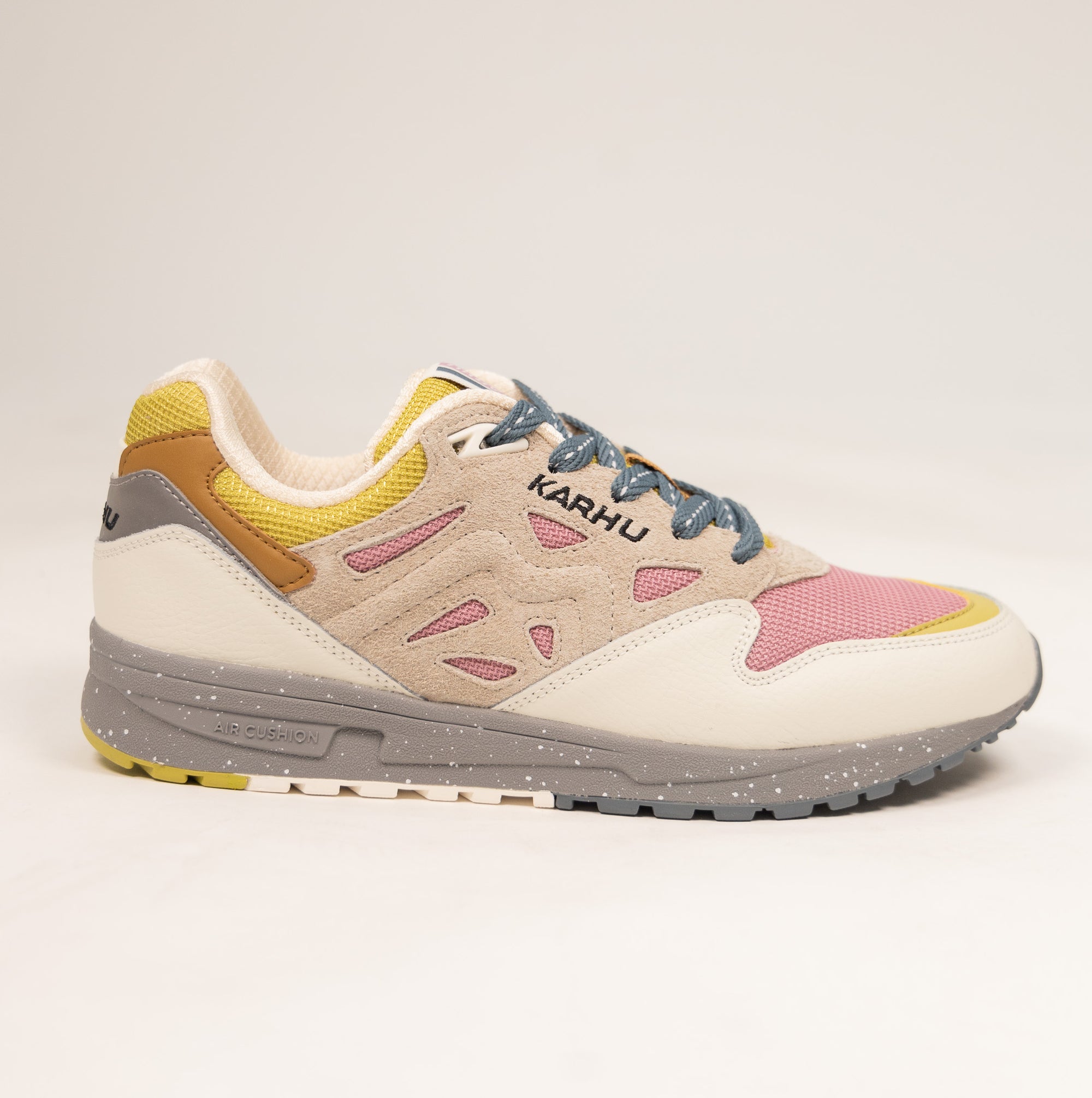 tan karhu women's shoe with grey speckled sole and pink and yellow details