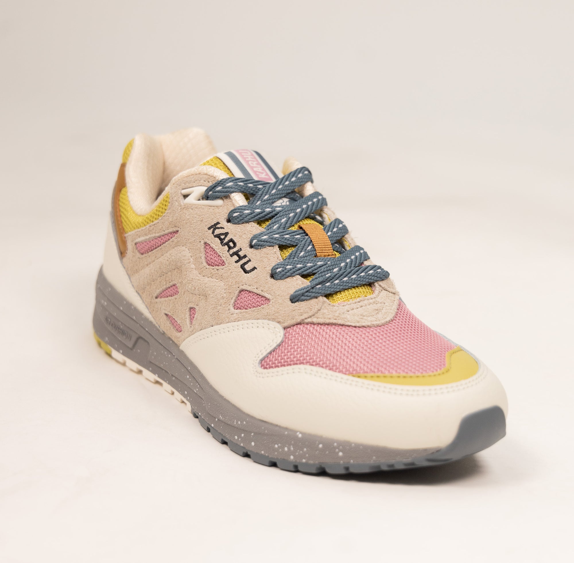 tan karhu women's shoe with grey speckled sole and pink and yellow details
