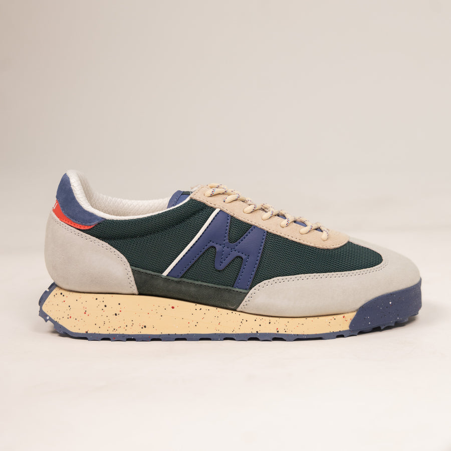 grey and green karhu men's shoe with speckled off white sole and blue details