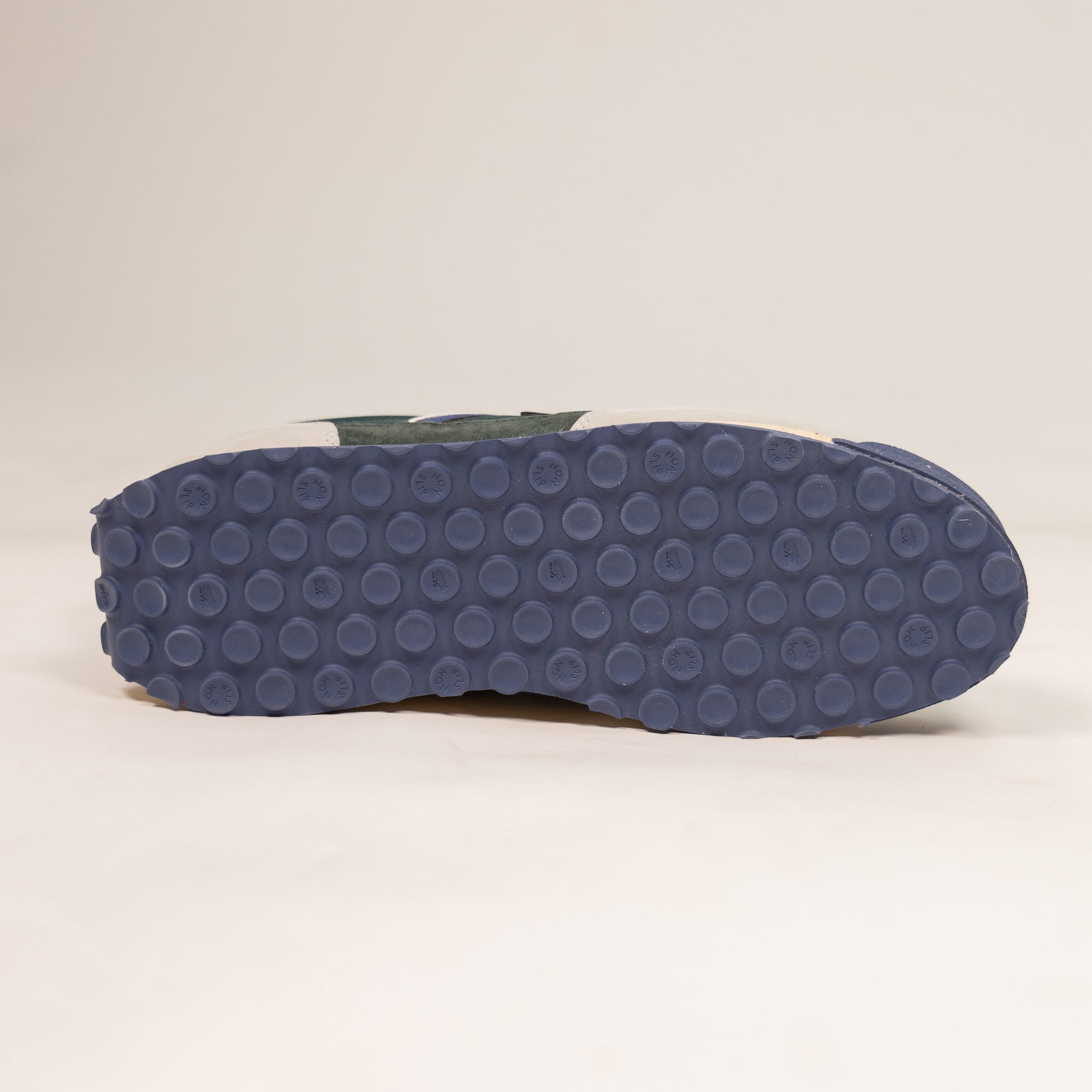 grey and green karhu men's shoe with speckled off white sole and blue details