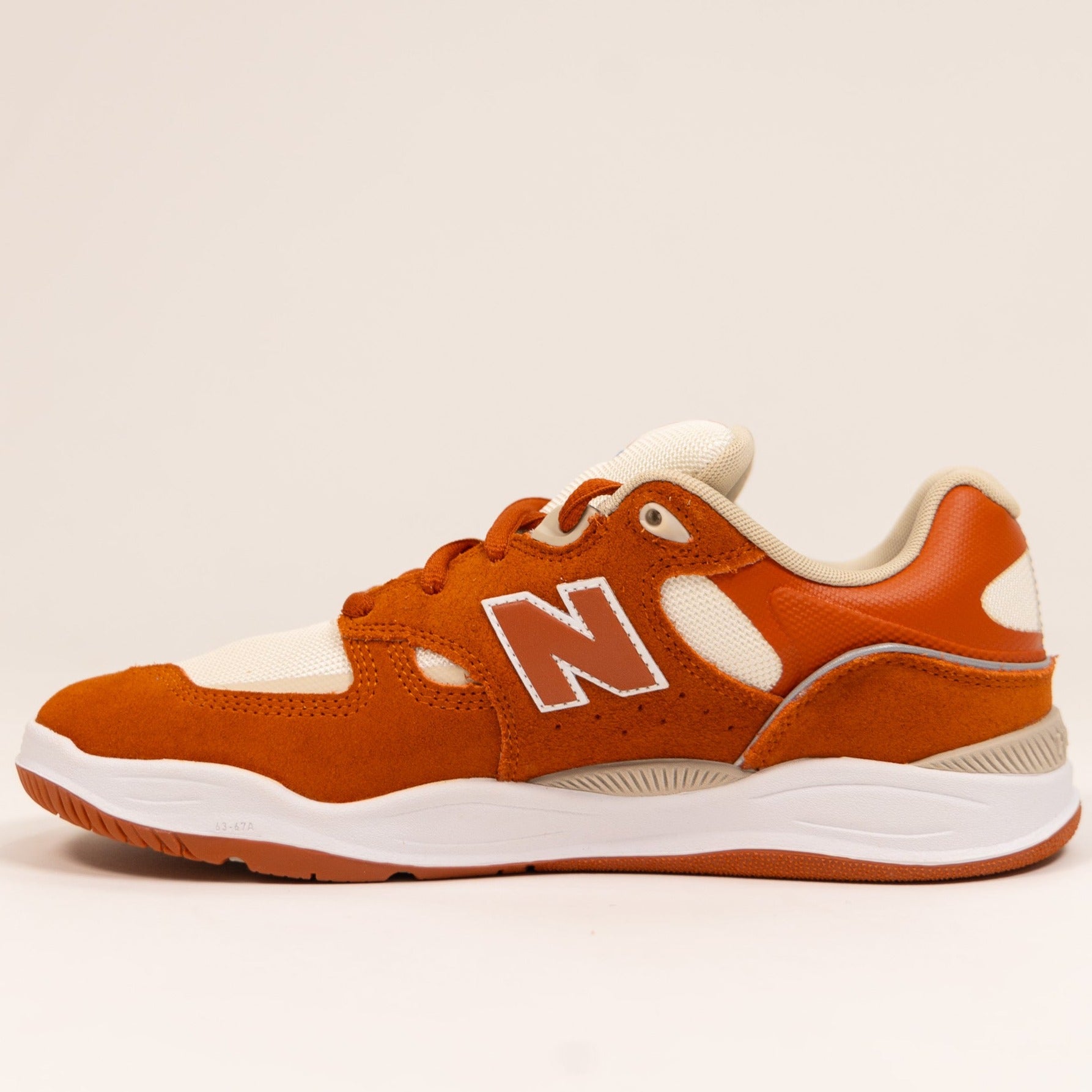 orange and white men's new balance skate shoe with white sole