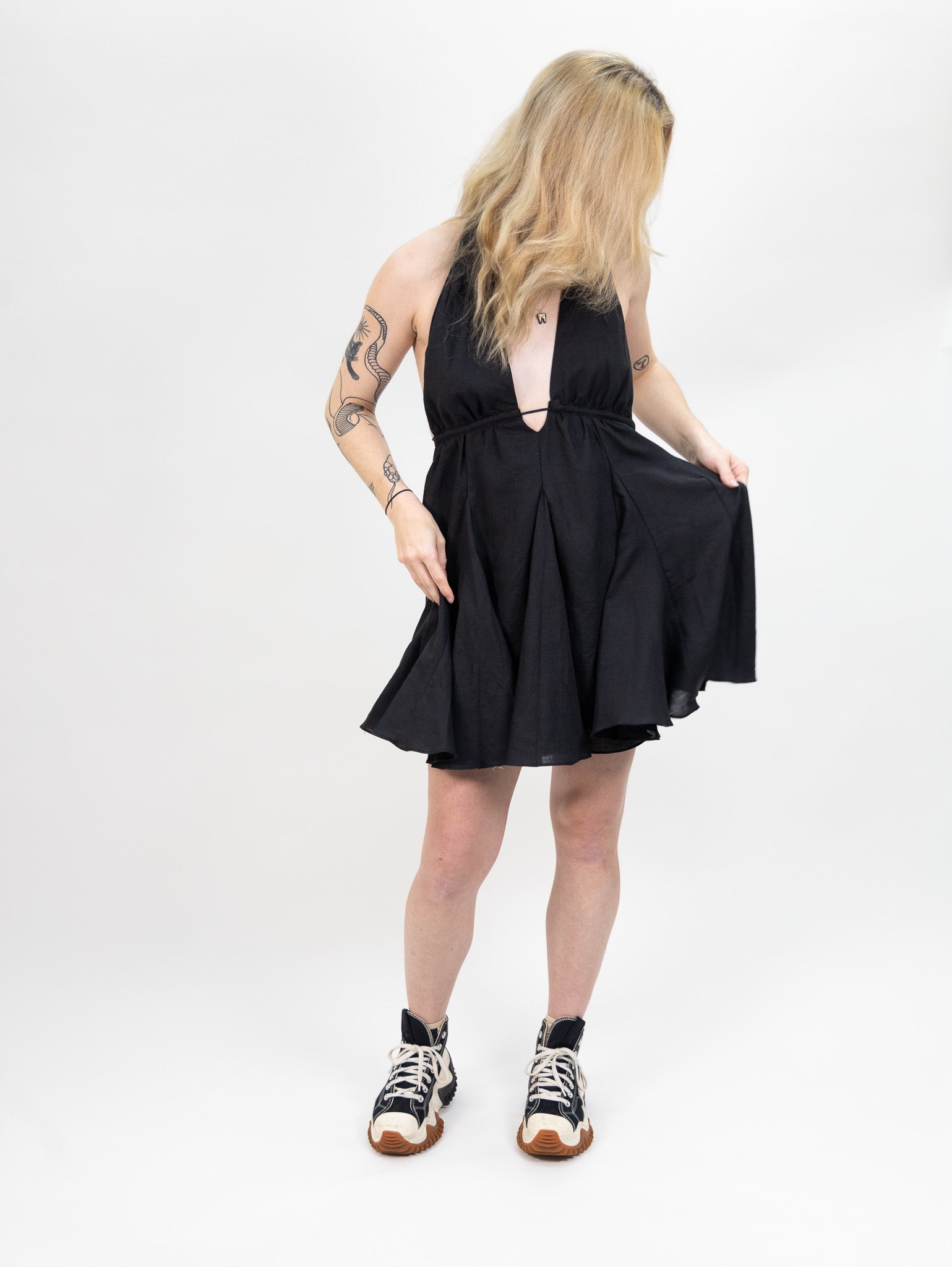women's black Linen mini dress featuring a deep halter V-neck and open back from nia