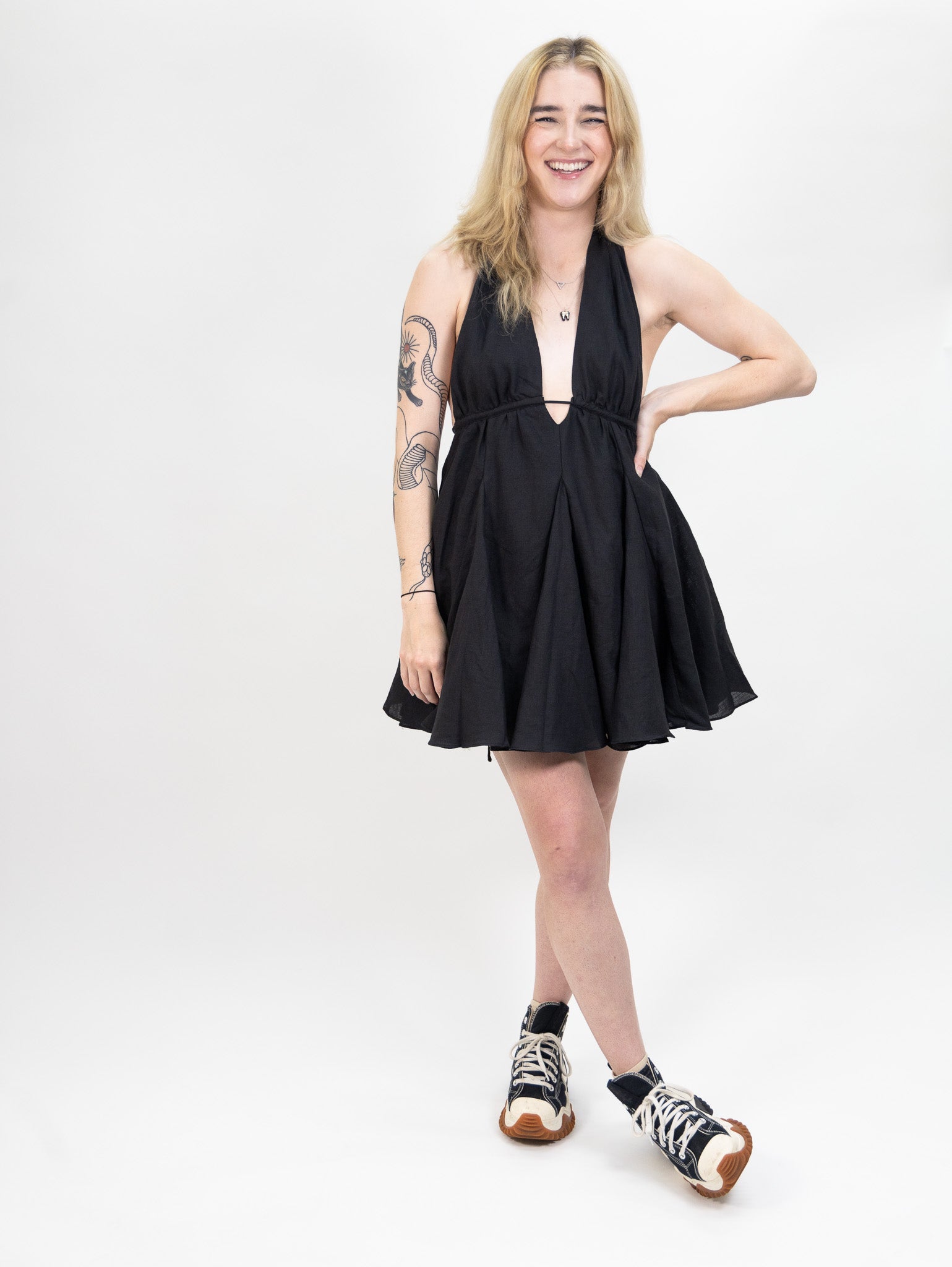 women's black Linen mini dress featuring a deep halter V-neck and open back from nia