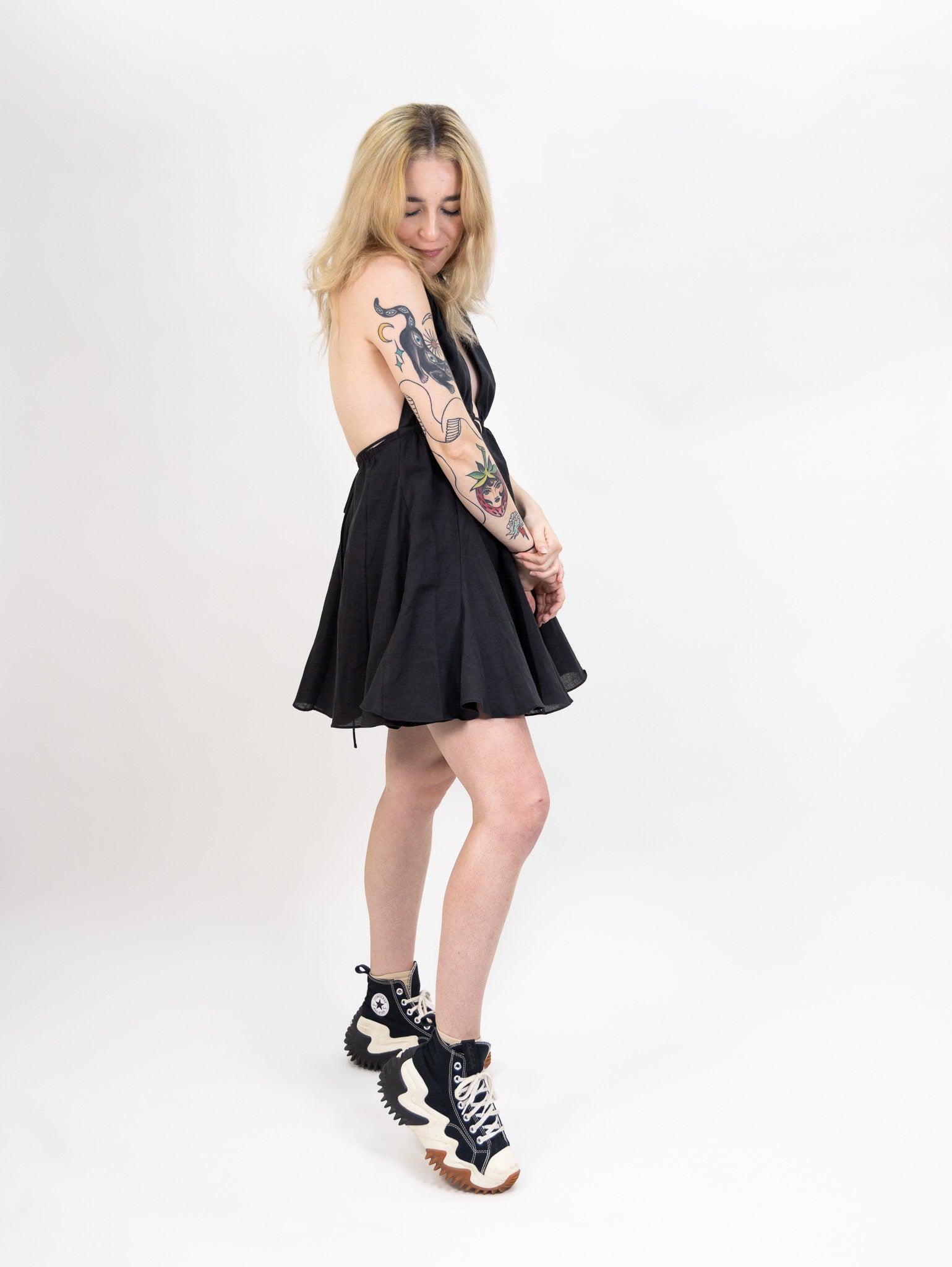 women's black Linen mini dress featuring a deep halter V-neck and open back from nia