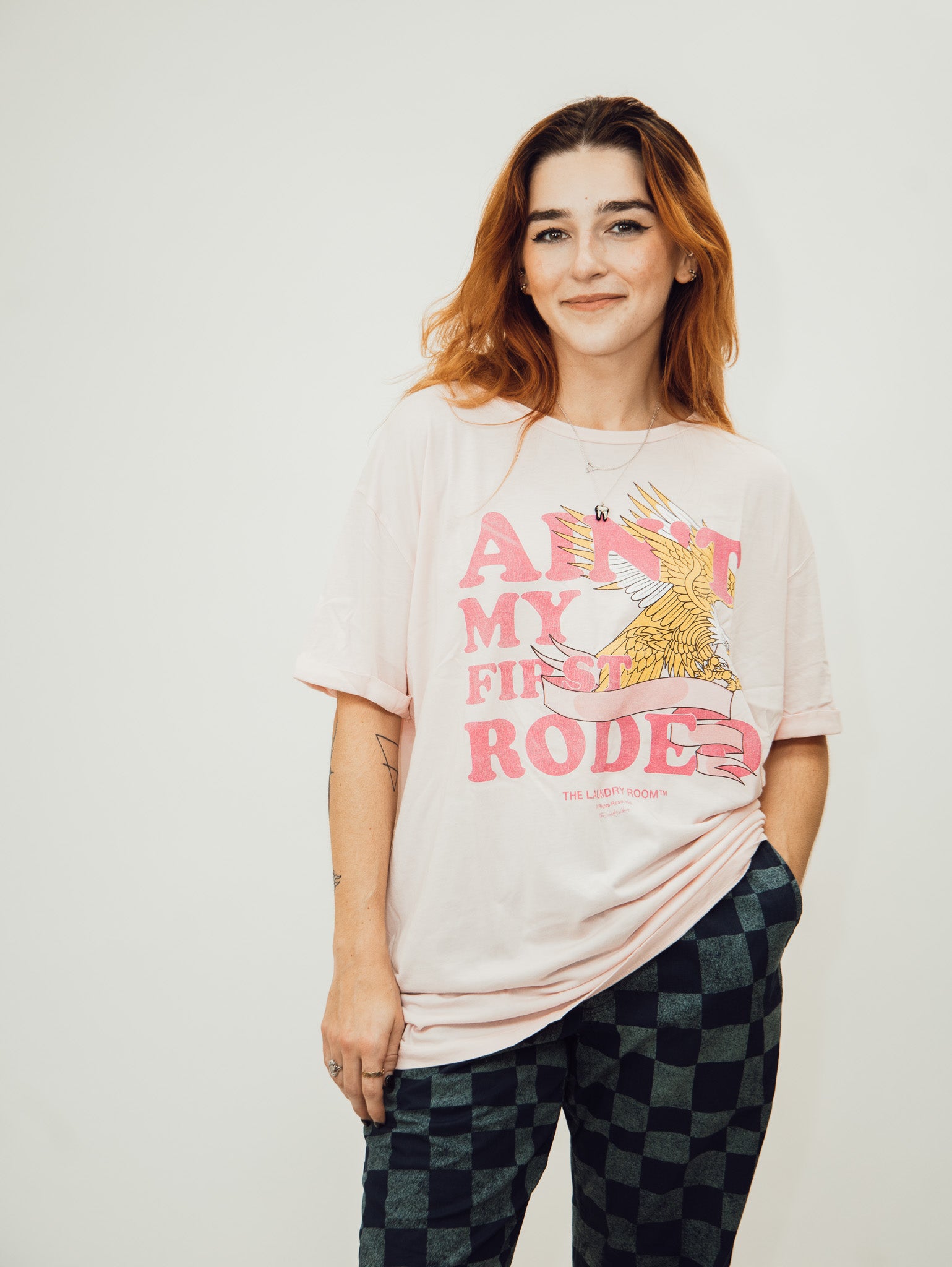 pink oversized women's tee shirt from the laundry room featuring the slogan ain't my first rodeo