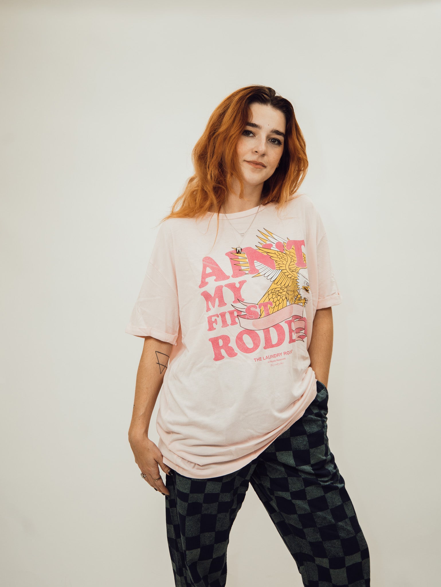 pink oversized women's tee shirt from the laundry room featuring the slogan ain't my first rodeo