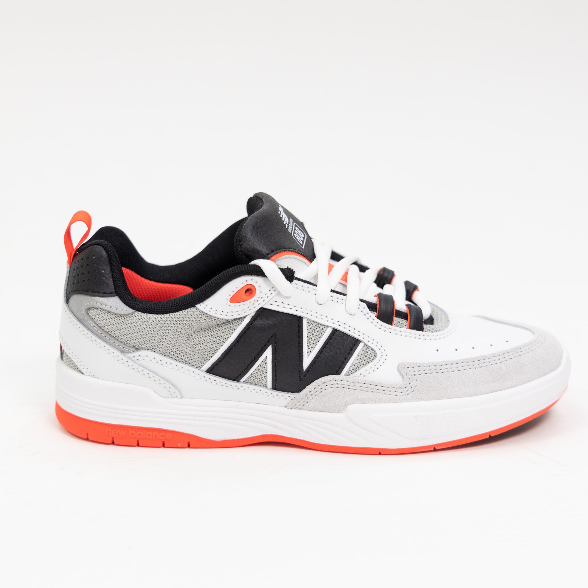 white and black new balance men's skate shoe with bright red detail