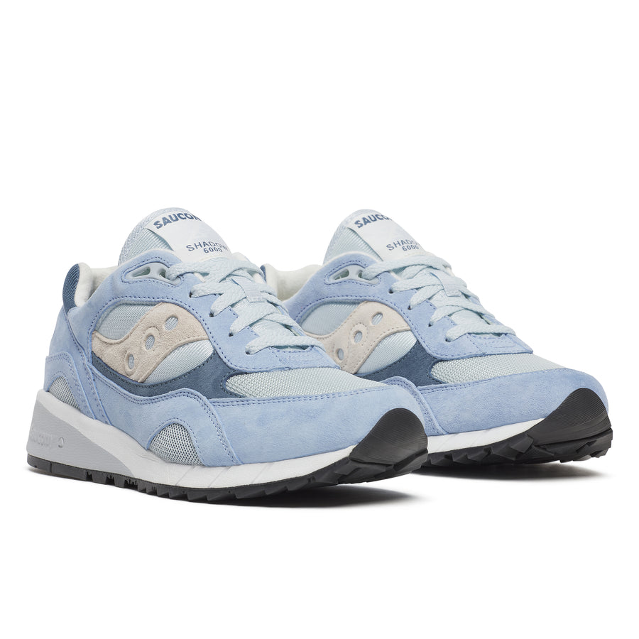 Blue saucony shadow 6000 plein air sneaker with white accents on a white background