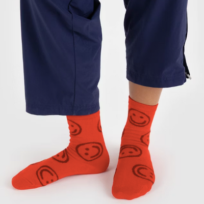 red baggu crew sock featuring smiley faces