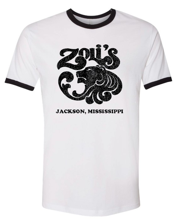 A white ringer t-shirt with black trim on the crew neck and sleeve cuffs, featuring a distressed black graphic of a lion and the text 'Zoli's Jackson, Mississippi' on the front.