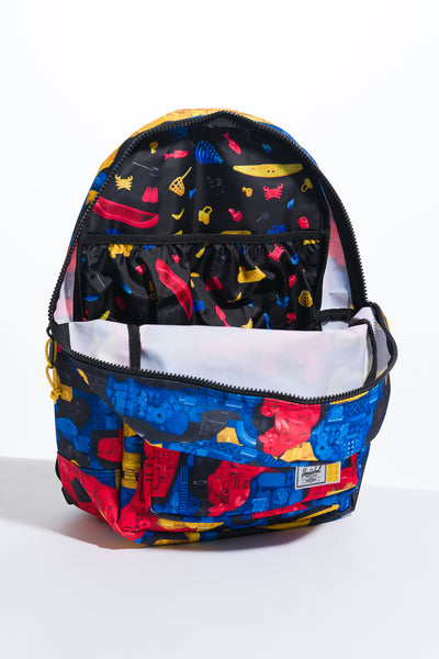 multi-colored herschel x lego heritage youth backpack featuring lego bricks