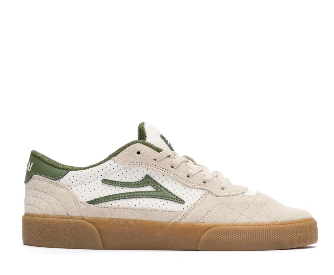 tan lakai cambridge skateboarding sneaker with green accents on a white background