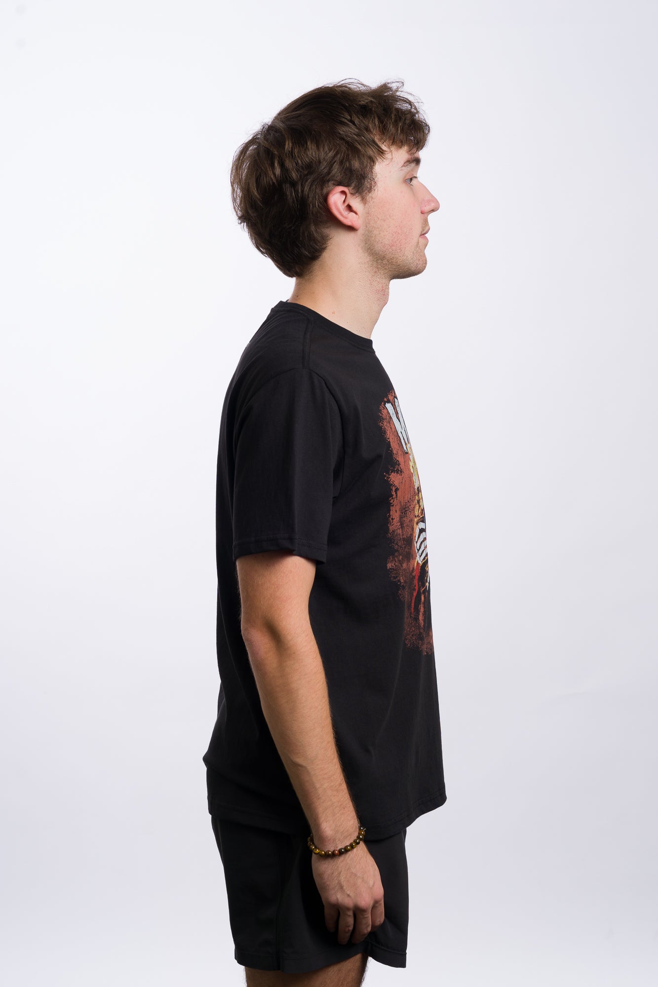 Person wearing a black t-shirt with 'Misfits' graphic design on a white background