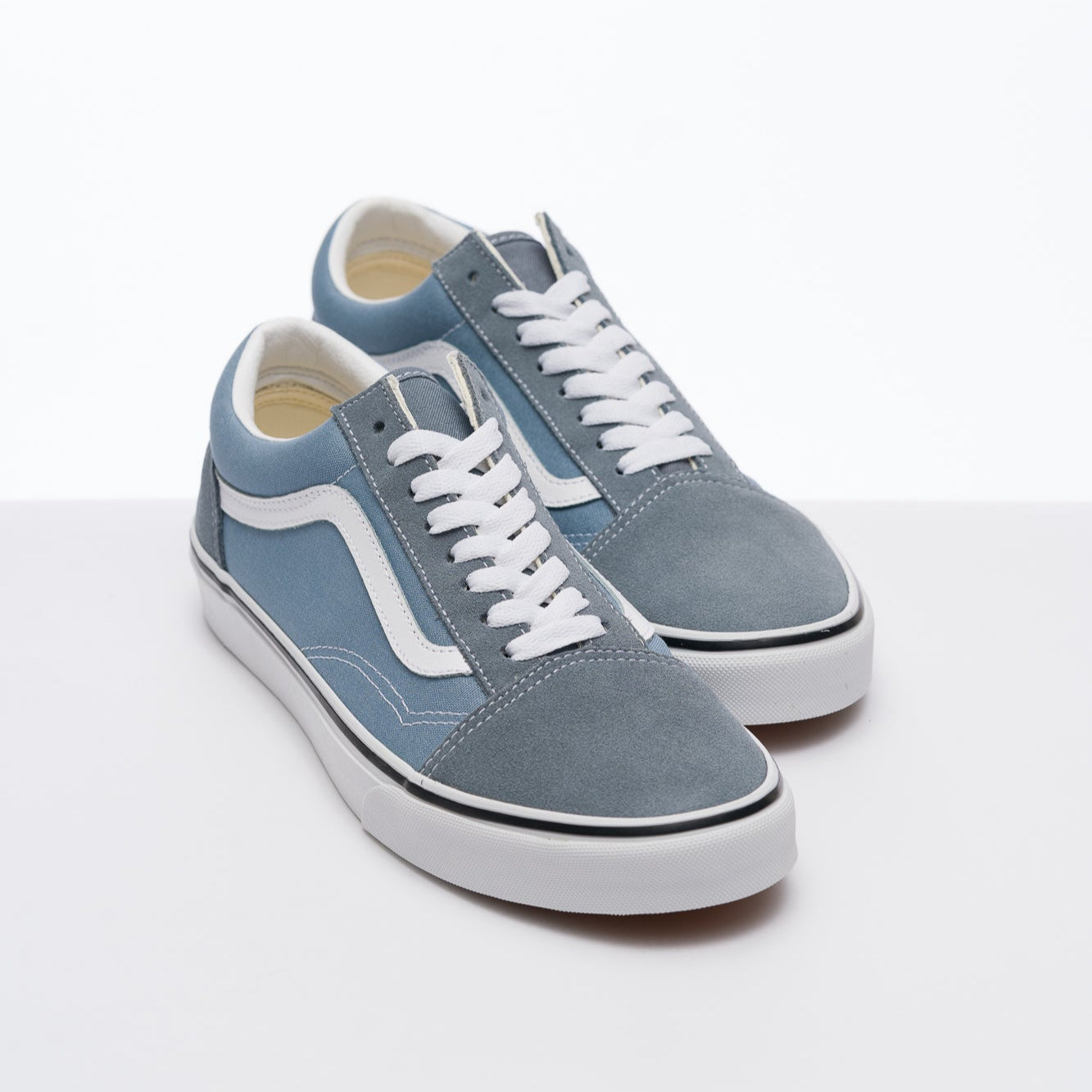 Blue vans men's old skool sneaker with white sole on a white background