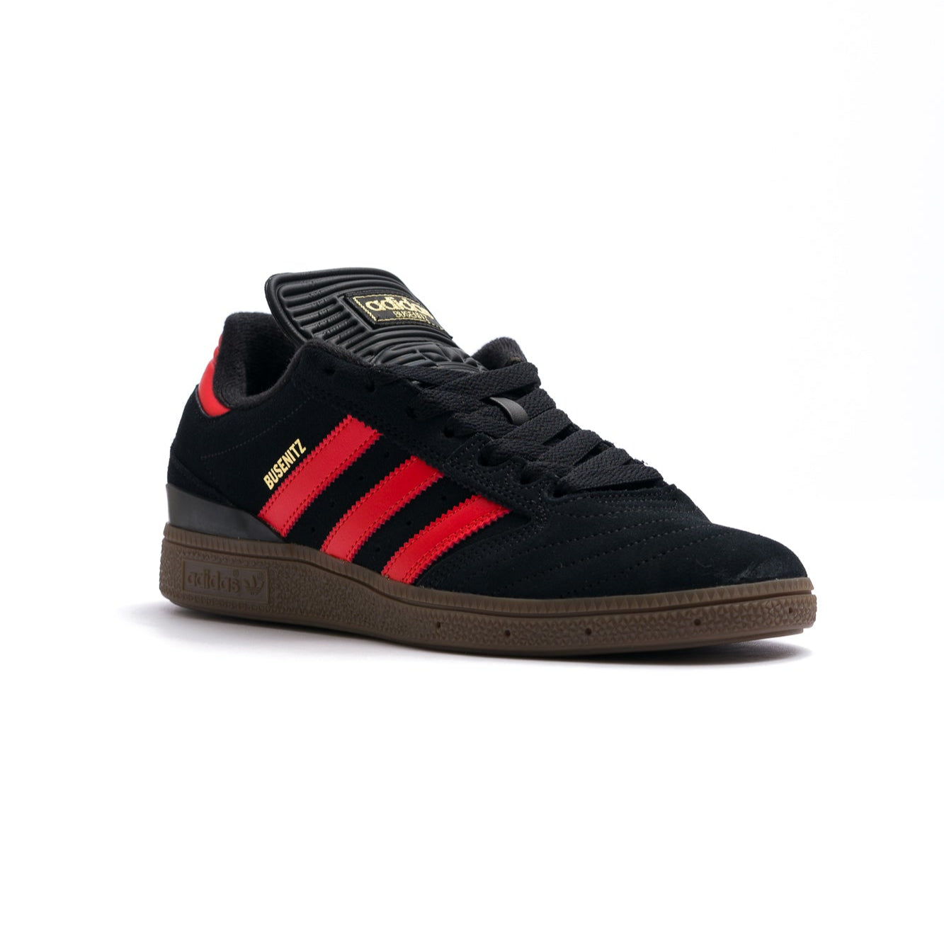 black adidas busentiz men's skate shoes with three orange stripes and a gum sole