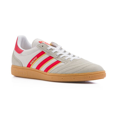 Grey adidas men's busenitz vintage skate shoe with three red and yellow stripes and gum sole