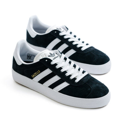 black suede adidas gazelle skate shoe with white stripes and a white sole