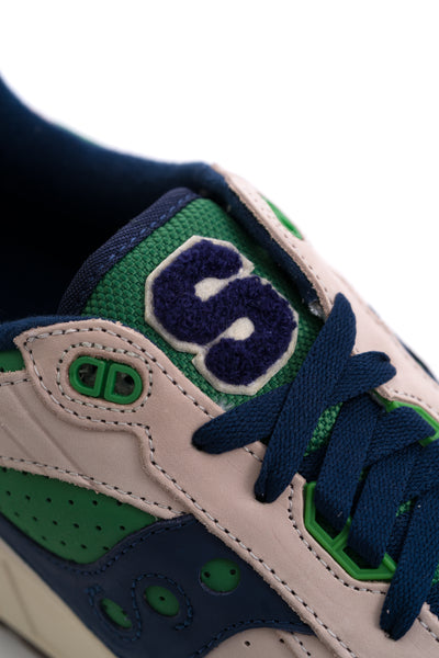 grey saucony men's shoe with green and navy blue details