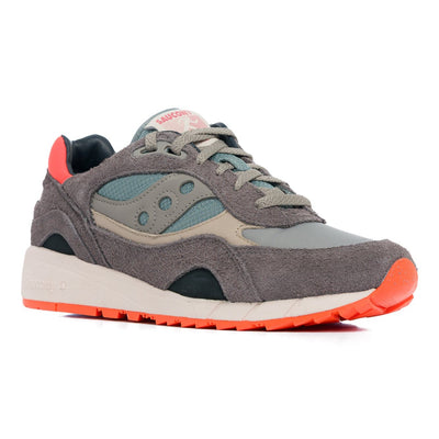 green and grey saucony shadow 6000 women'sand men's comfort shoe with green and orange detail and an off white sole