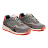 green and grey saucony shadow 6000 women'sand men's comfort shoe with green and orange detail and an off white sole