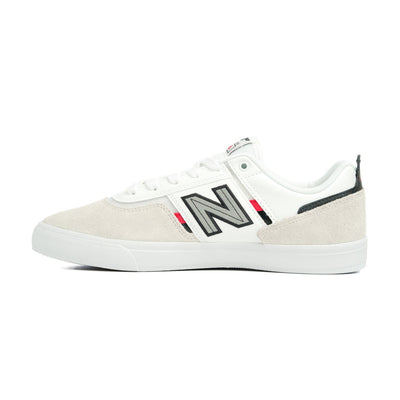 white men's new balance shoe with read and black details and a white sole