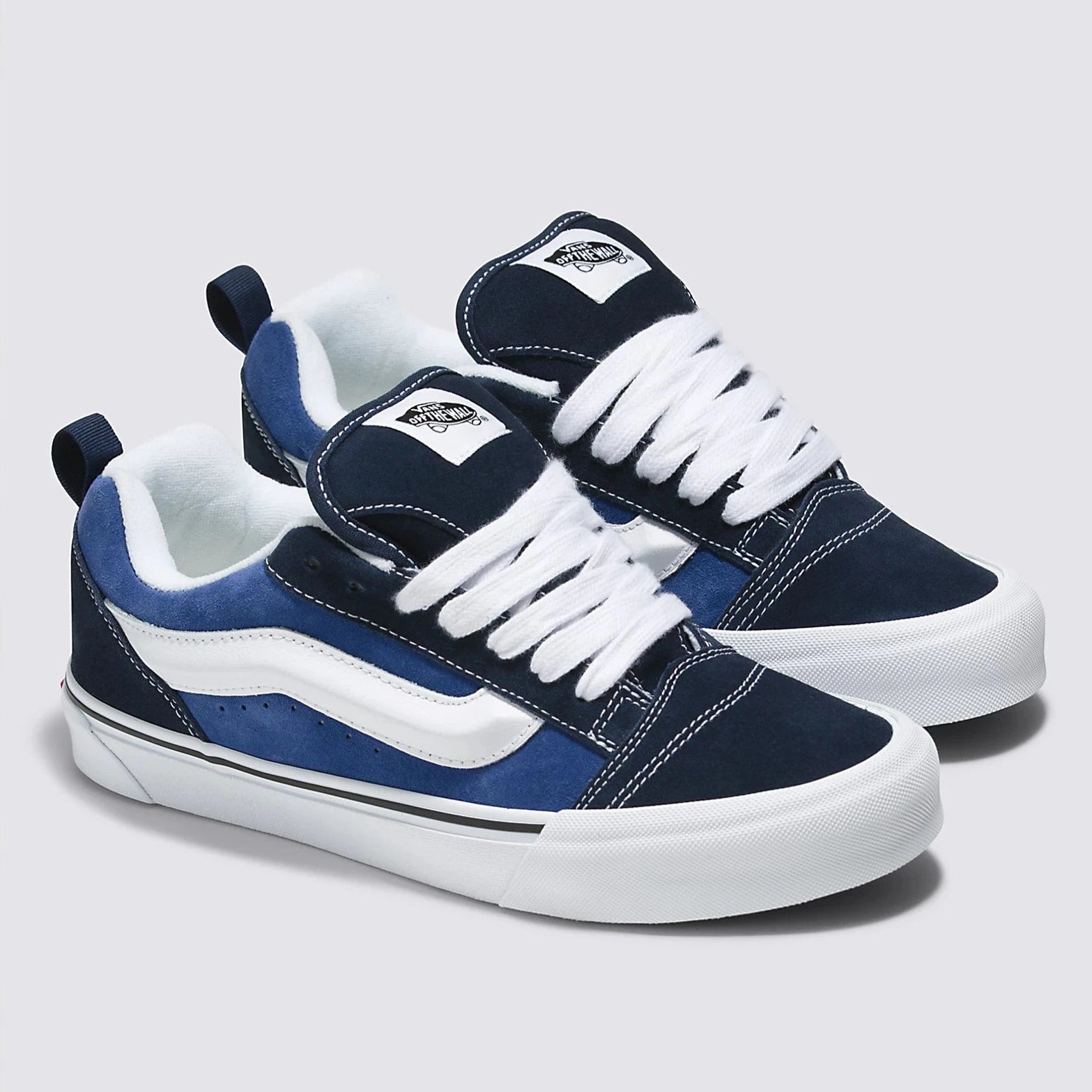 navy blue men's and women's knu skool shoe with white sidestripe and white sole