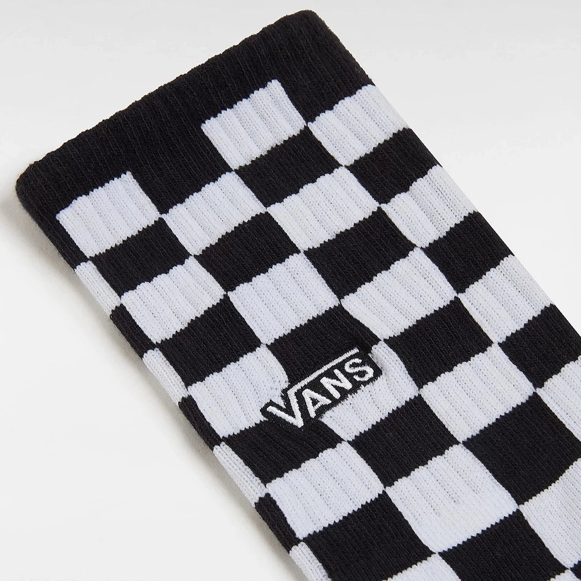 Ankle of checkered Vans socks with the Vans logo.