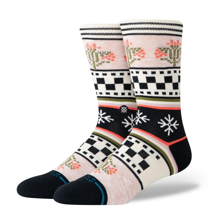Pair of patterned stance women's crew socks with black, white, and multicolor design on a transparent background