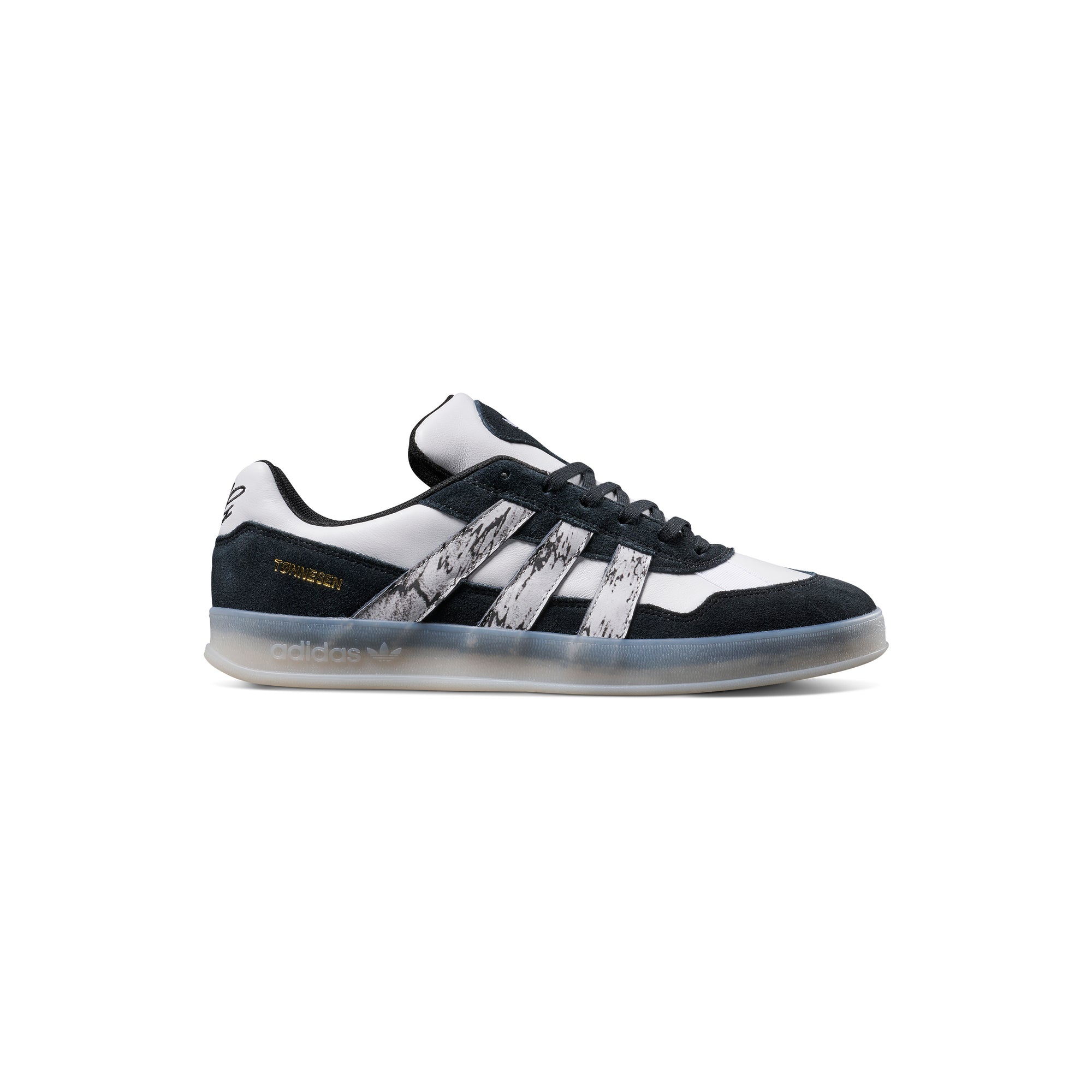 Black and white adidas x gustav tonnesen aloha sneaker with Adidas logo and a clear sole on a white background