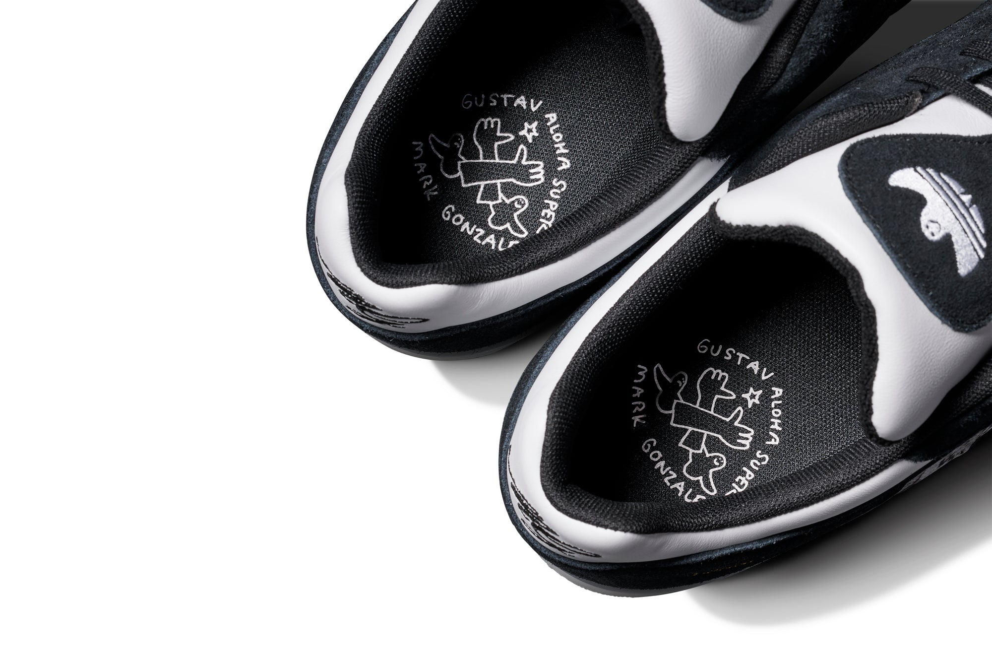 Black and white adidas x gustav tonnesen aloha sneaker with Adidas logo and a clear sole on a white background
