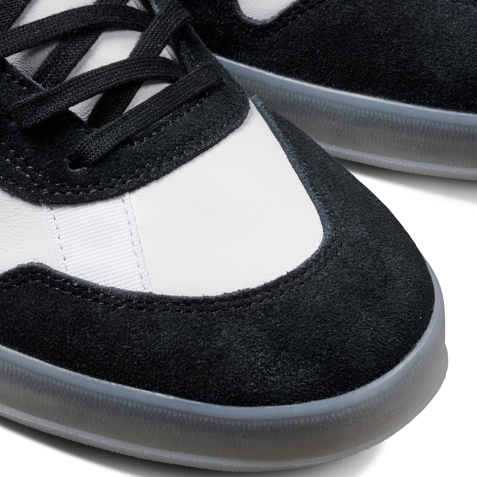 Black and white adidas x gustav tonnesen aloha sneaker with Adidas logo and a clear sole on a white background