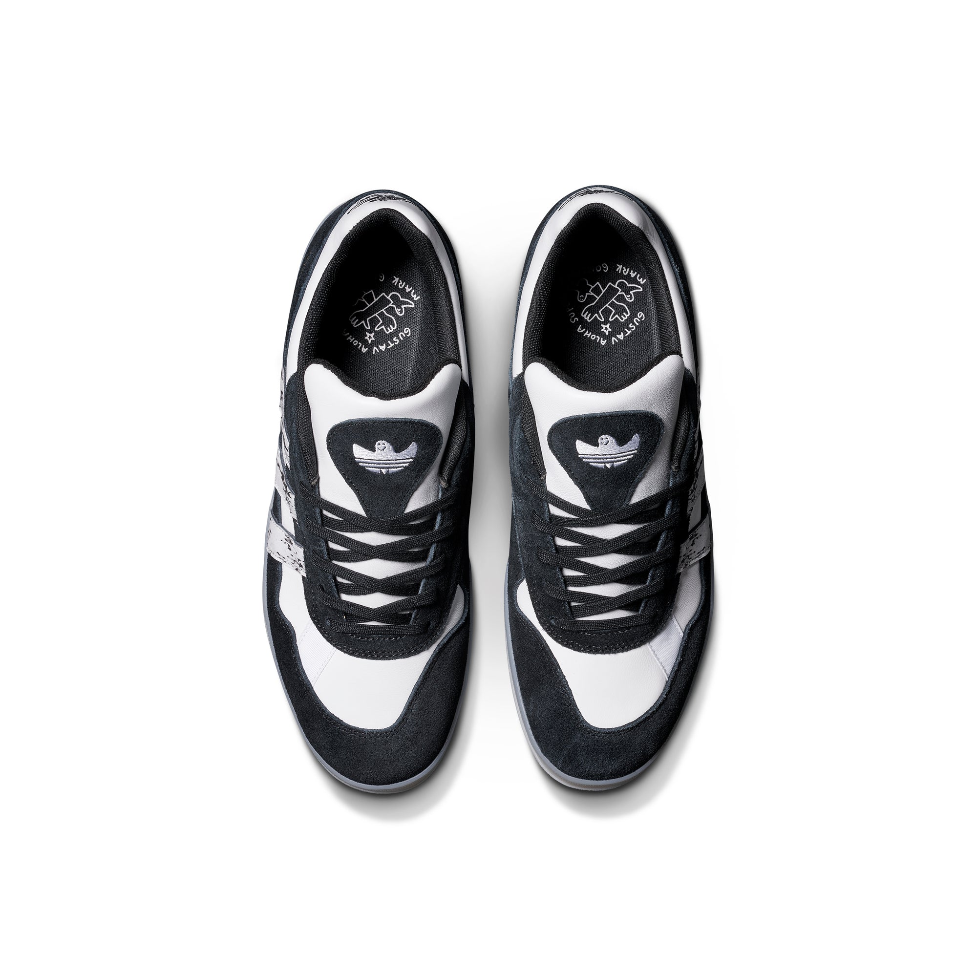 Black and white adidas x gustav tonnesen aloha sneaker with Adidas logo and a clear sole on a white background