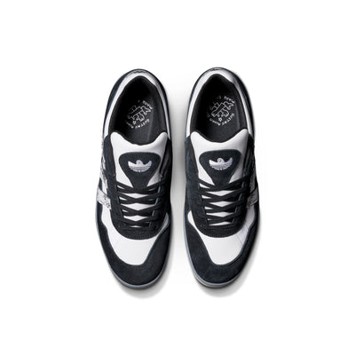 Black and white adidas x gustav tonnesen aloha sneaker with Adidas logo and a clear sole on a white background